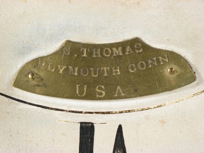 The brass nameplate on on the dial. S. THOMAS PLYMOUTH CONN U S A