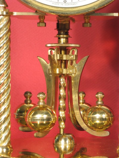 Earlier type of mounting nuts (long). Earlier type of pendulum (has slots in upper part of arms).