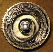 The broken mainspring still in the barrel