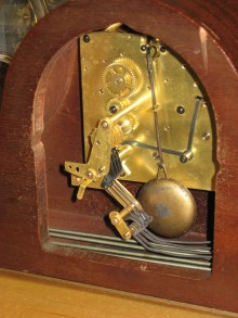 Movement in case showing pendulum bob.